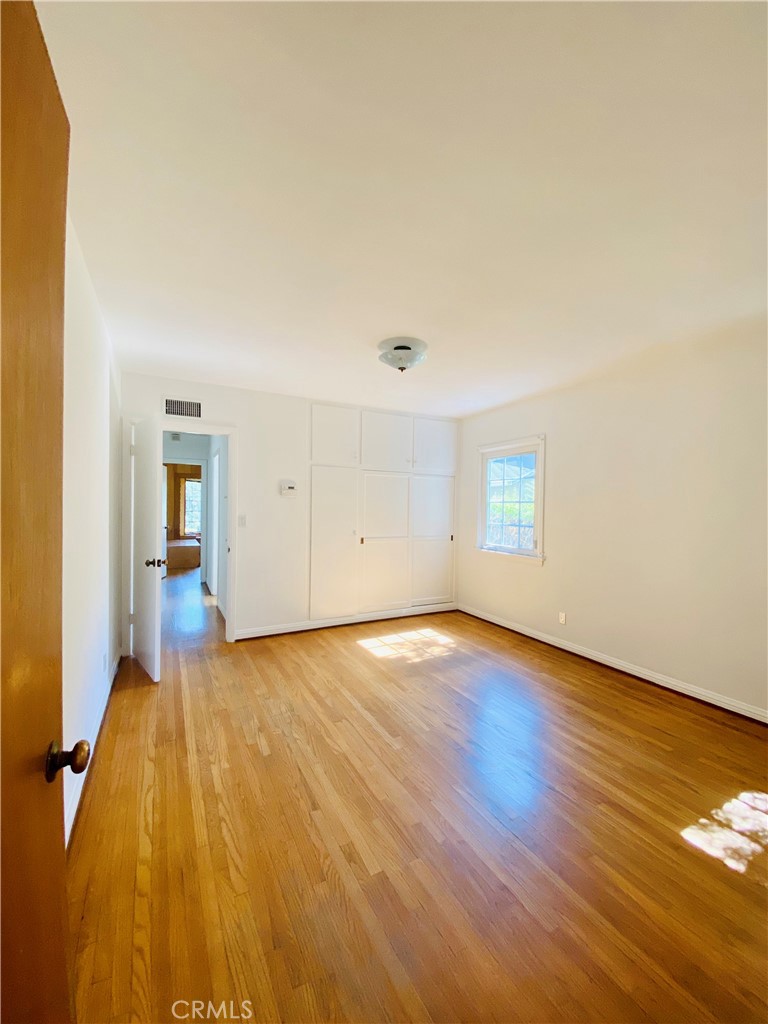 1917 Lyans Drive La Canada Flintridge, CA 91011 - Photo 19 of 25 an empty room with wooden floor and closet