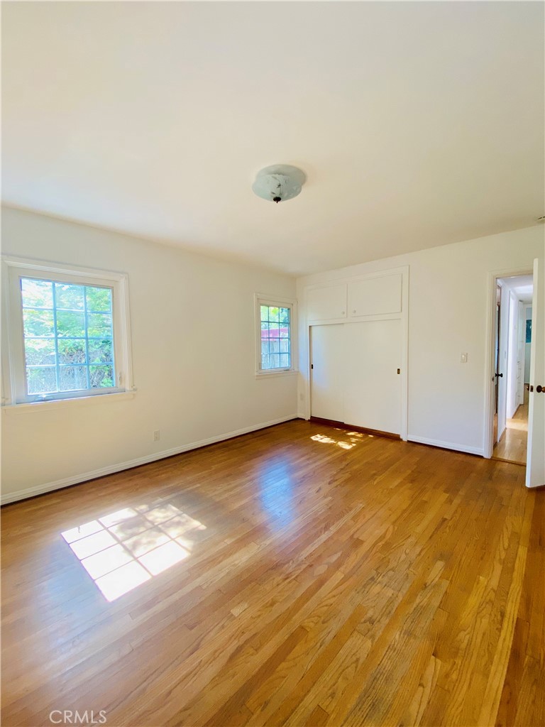 1917 Lyans Drive La Canada Flintridge, CA 91011 - Photo 20 of 25 an empty room with wooden floor and windows
