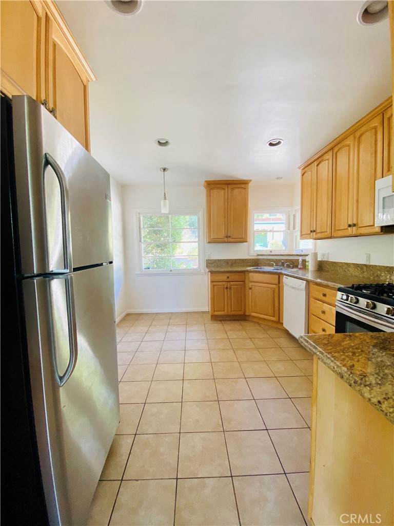 1917 Lyans Drive La Canada Flintridge, CA 91011 - Photo 10 of 25 a kitchen with stainless steel appliances granite countertop a refrigerator sink and cabinets