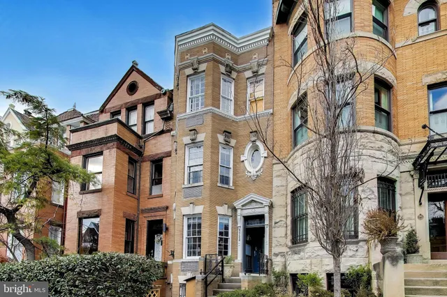 a view of a white building among the street with building