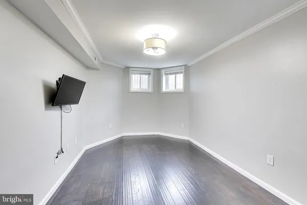 a view of a livingroom with wooden floor and a window