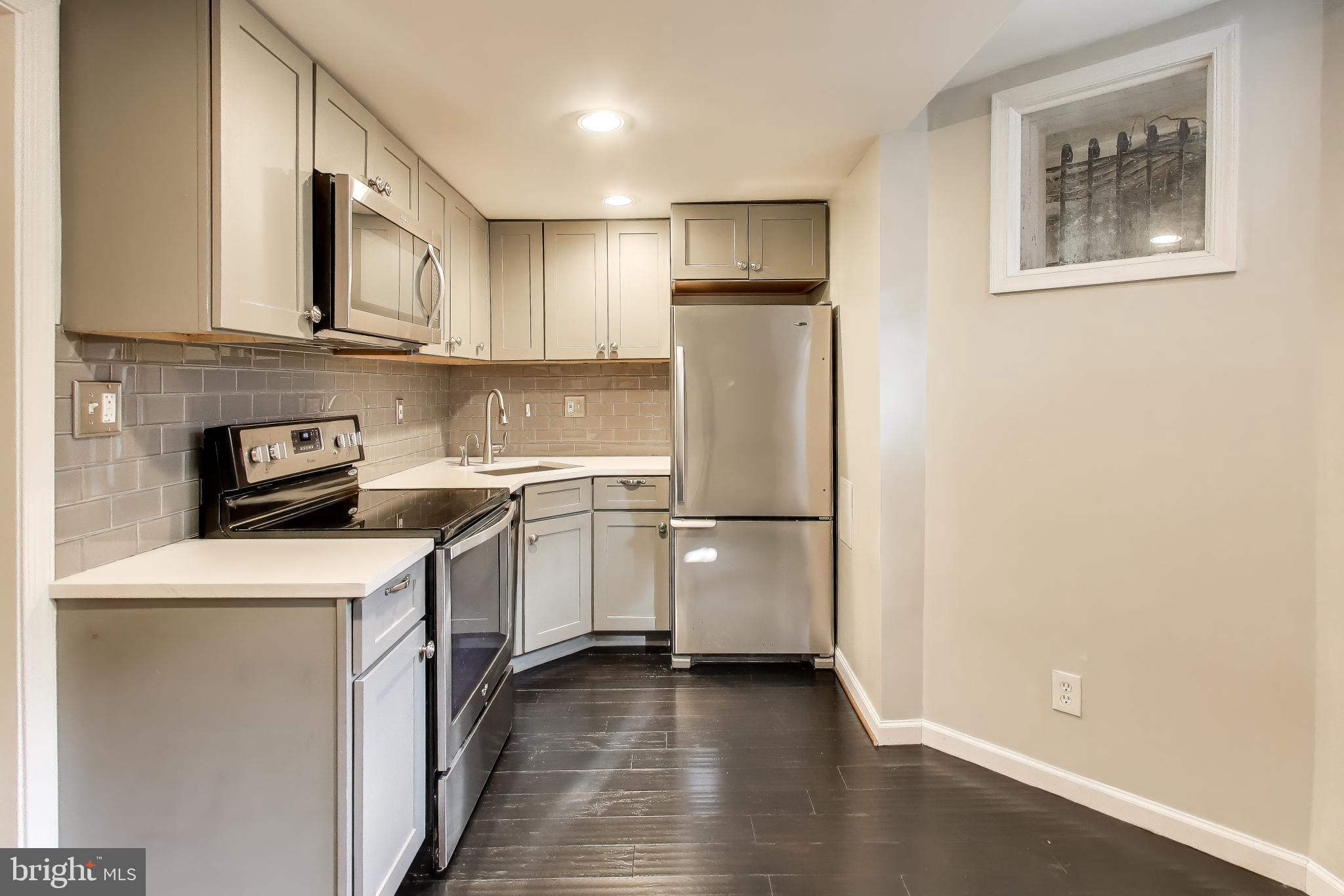 1724 21st Street Northwest, Unit 1 Washington, DC 20009 - Photo 5 of 17 a kitchen with stainless steel appliances a refrigerator sink and cabinets