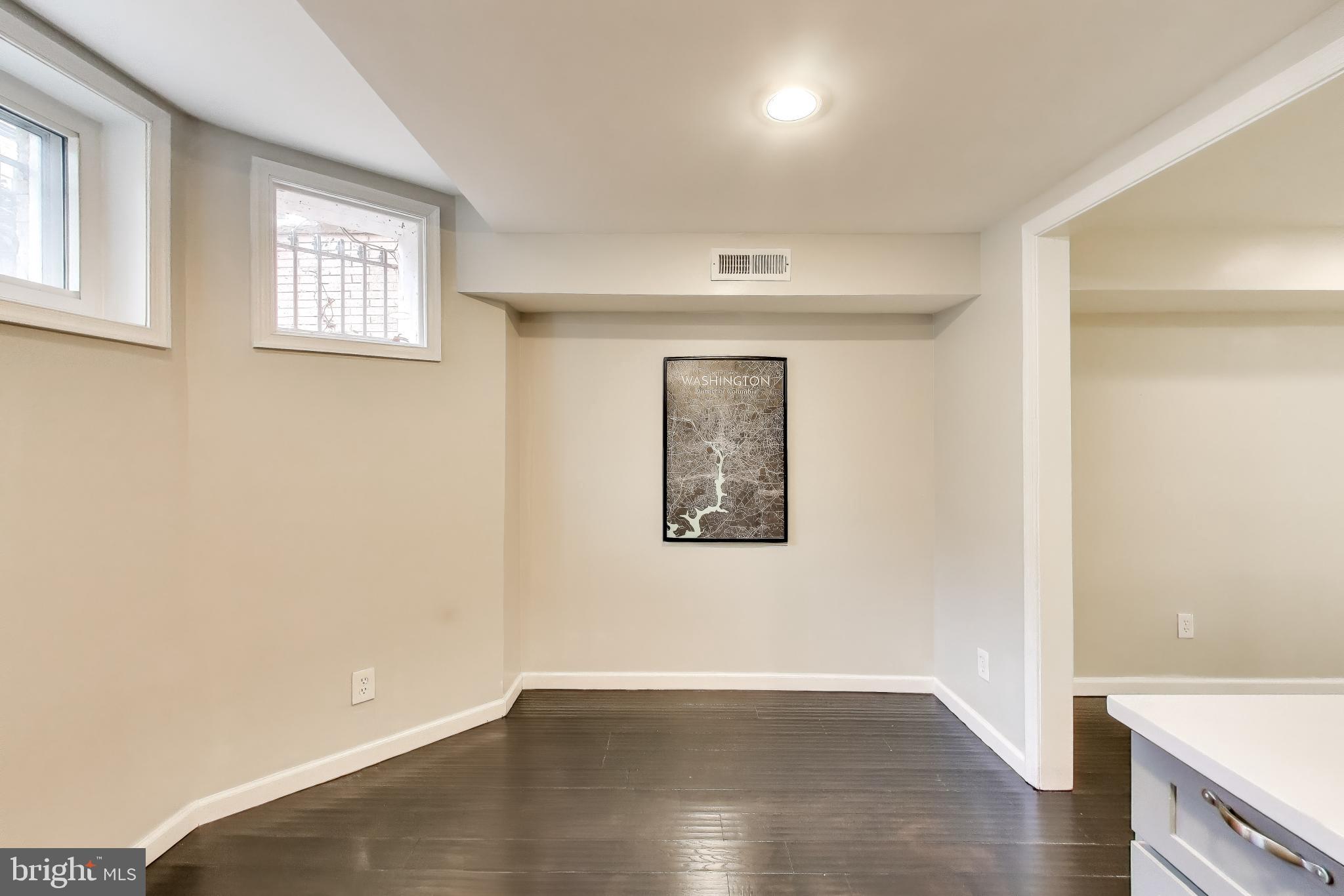 1724 21st Street Northwest, Unit 1 Washington, DC 20009 - Photo 8 of 17 an empty room with wooden floor and windows