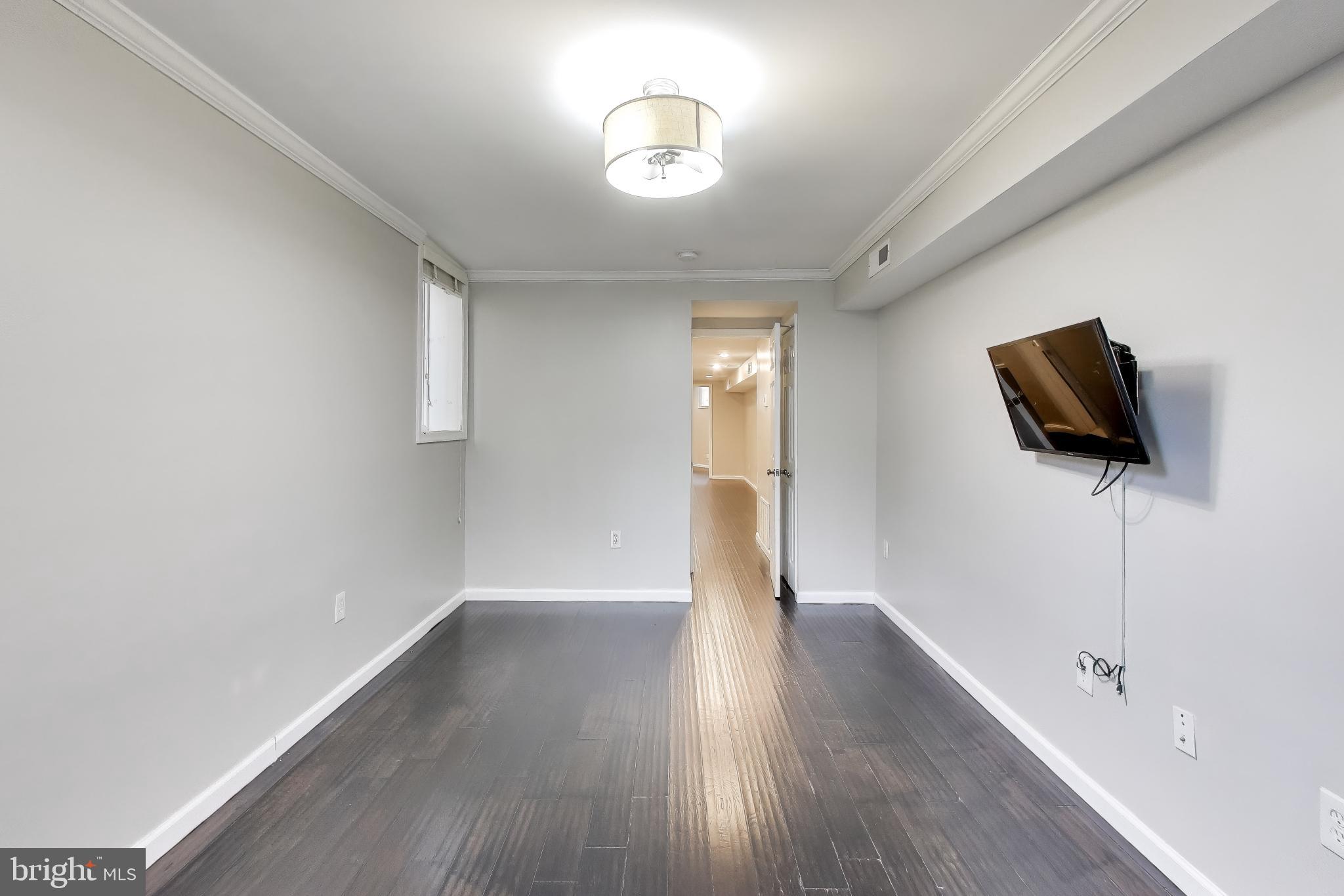 1724 21st Street Northwest, Unit 1 Washington, DC 20009 - Photo 10 of 17 a view of room with wooden floor and ceiling fan