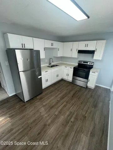 a kitchen with stainless steel appliances a refrigerator sink and stove