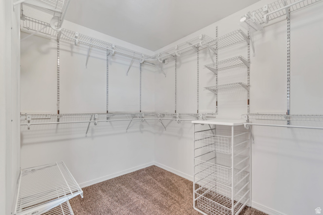 546 Wheatridge Road Tooele, UT 84074 - Photo 30 of 49 2nd bedroom with spacious walk-in closet featuring white wire shelving, multiple hanging rods