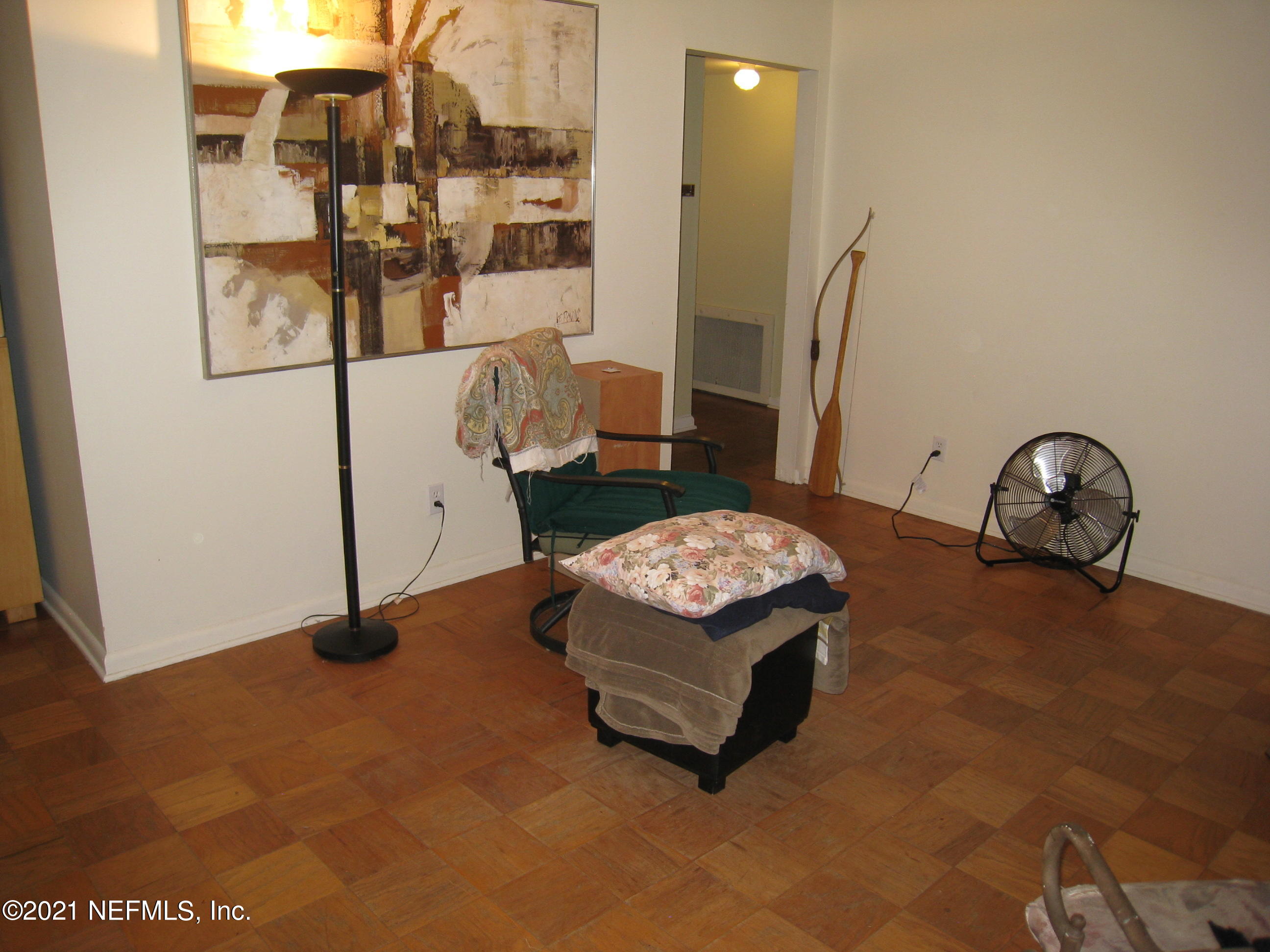 7052 Clovis Road Jacksonville, FL 32205 - Photo 11 of 34 a living room with furniture a rug and white walls