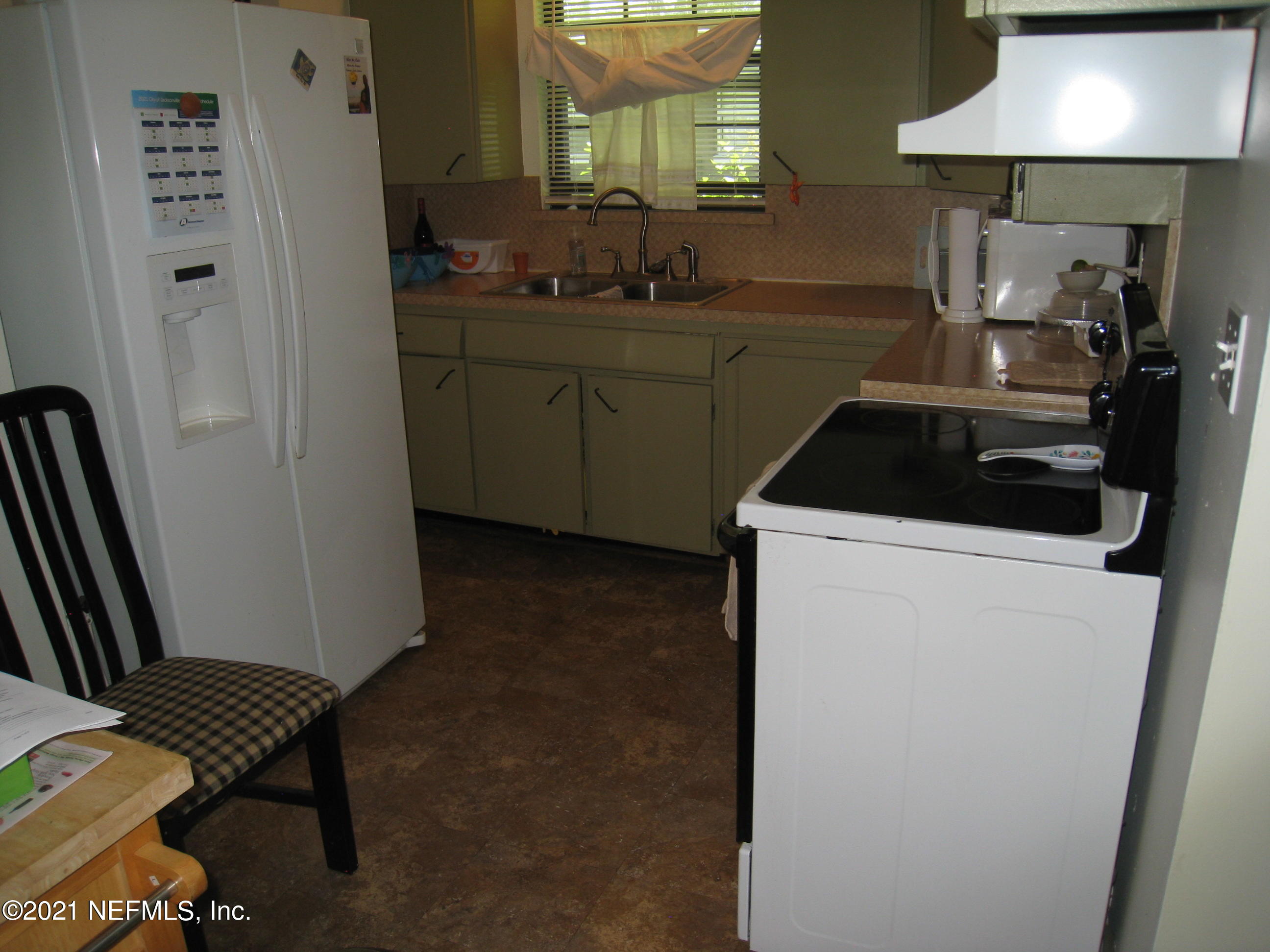 7052 Clovis Road Jacksonville, FL 32205 - Photo 26 of 34 a kitchen with a refrigerator and a stove
