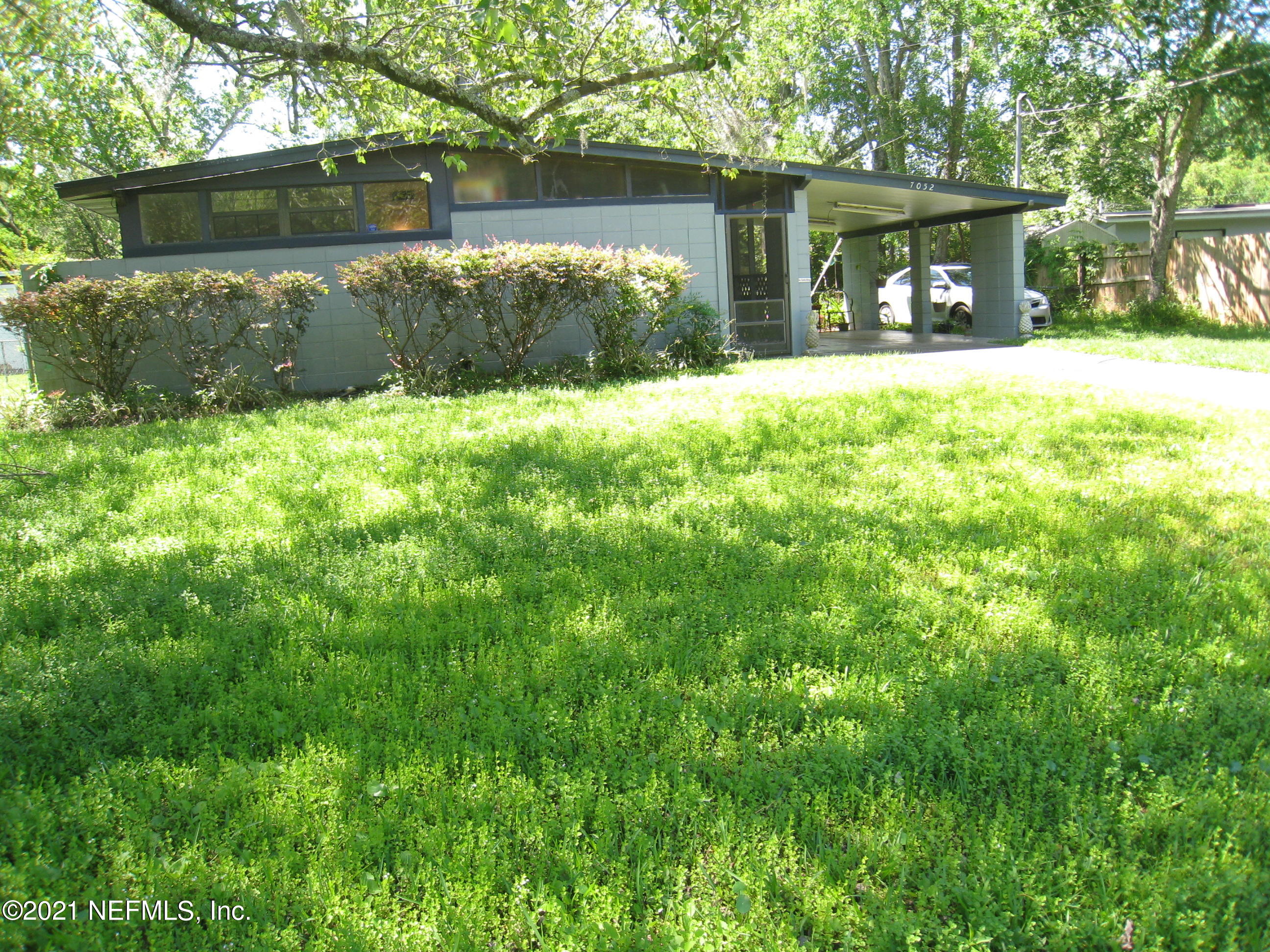 7052 Clovis Road Jacksonville, FL 32205 - Photo 4 of 34 a view of a house with a yard and large trees