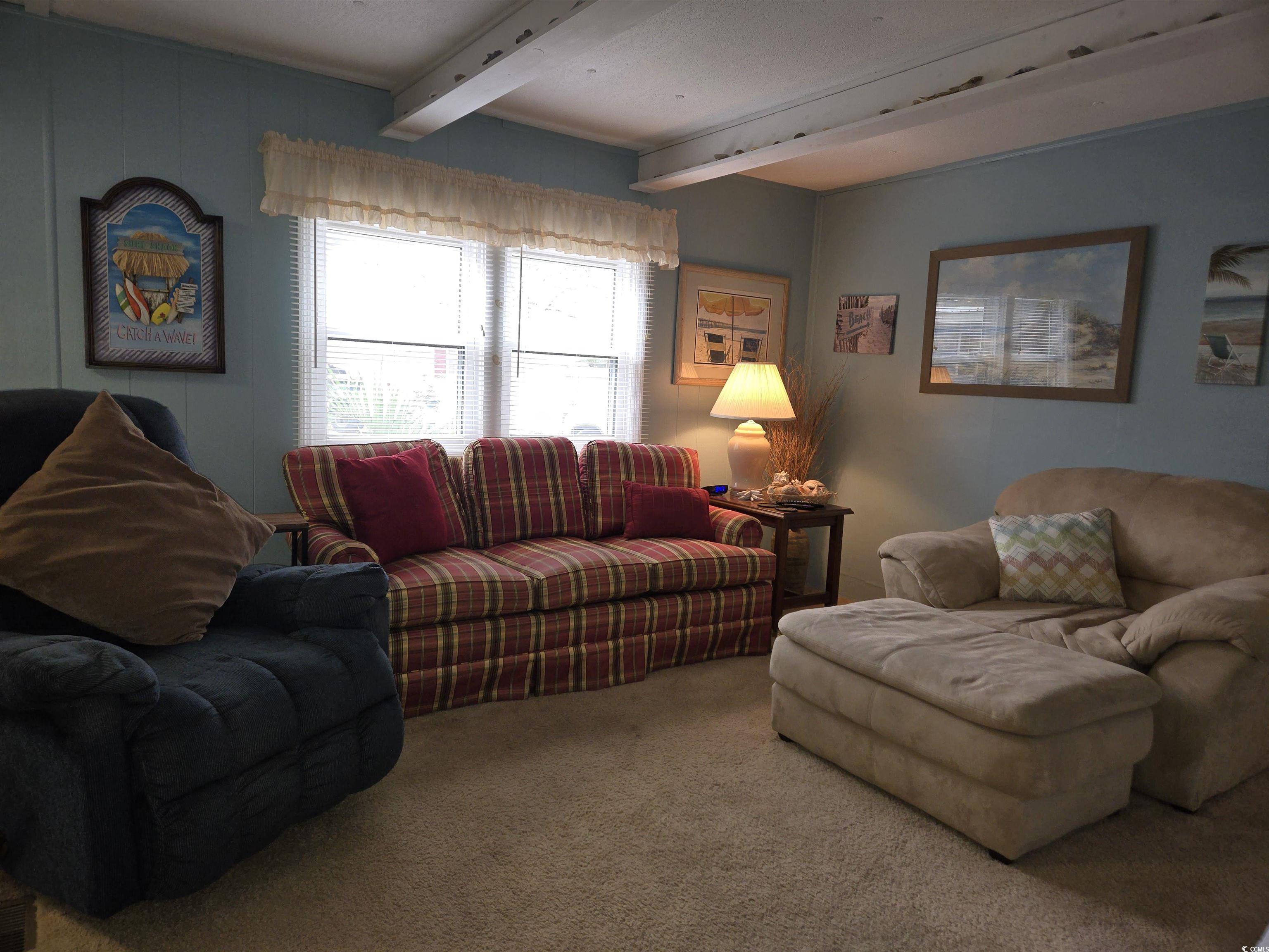 425 Delton Drive Murrells Inlet, SC 29576 - Photo 11 of 34 Carpeted living room with beam ceiling