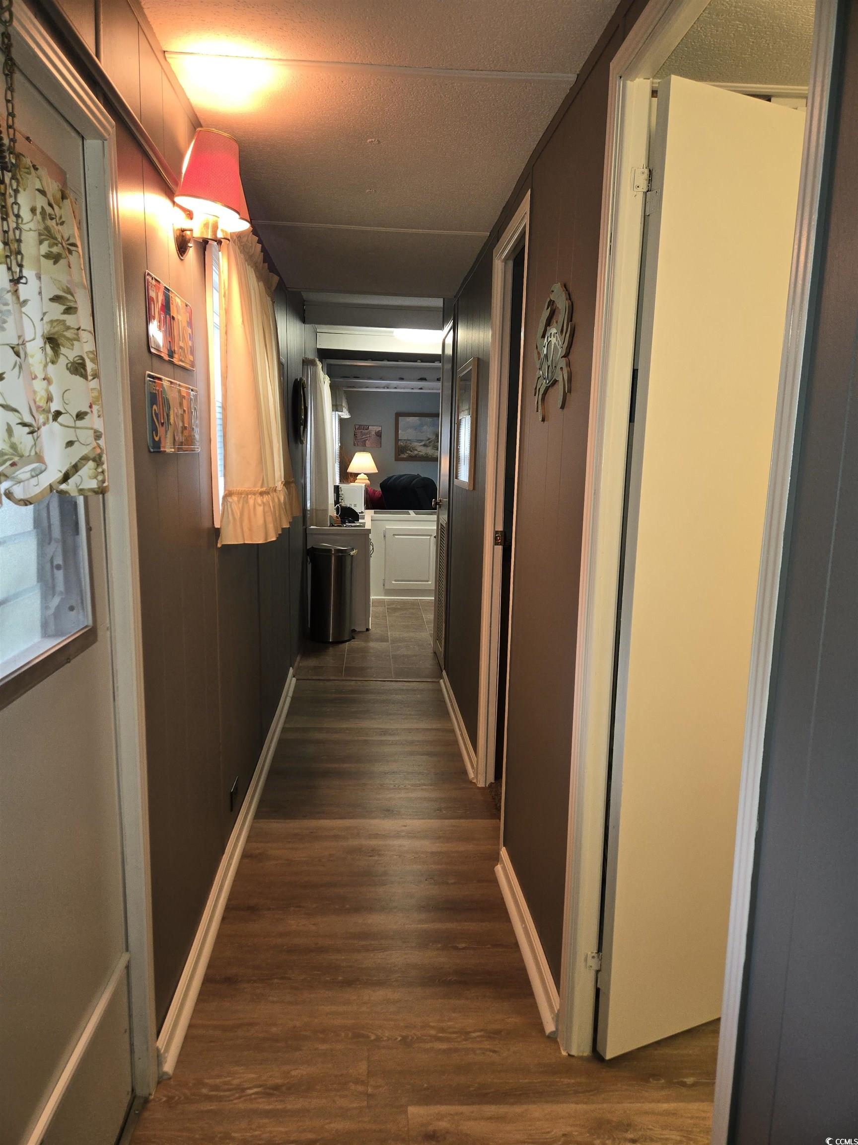 425 Delton Drive Murrells Inlet, SC 29576 - Photo 14 of 34 Corridor with baseboards, a textured ceiling, and dark wood finished floors
