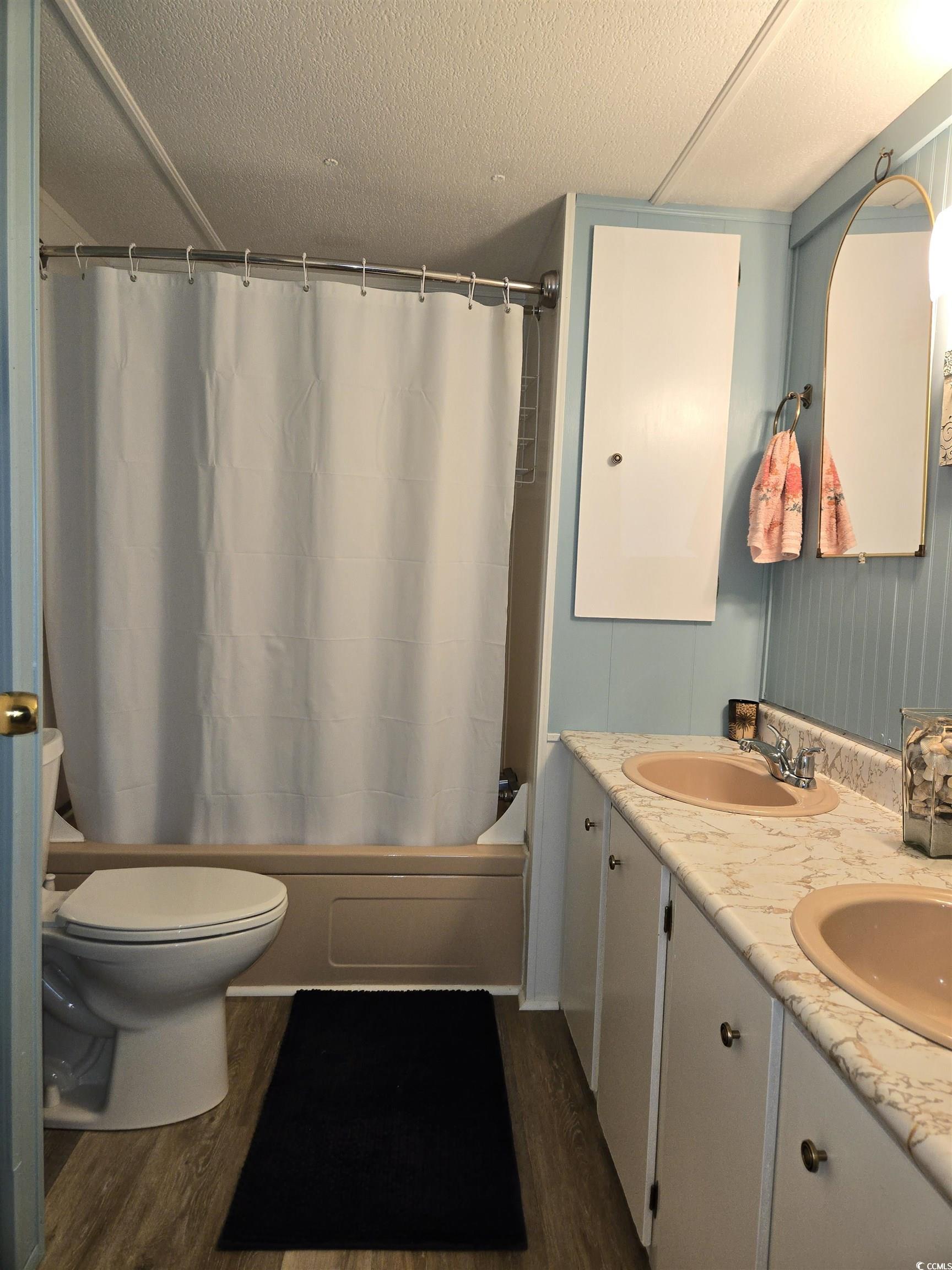 425 Delton Drive Murrells Inlet, SC 29576 - Photo 25 of 34 Full bath featuring shower / bath combination with curtain, toilet, wood finished floors, and a sink