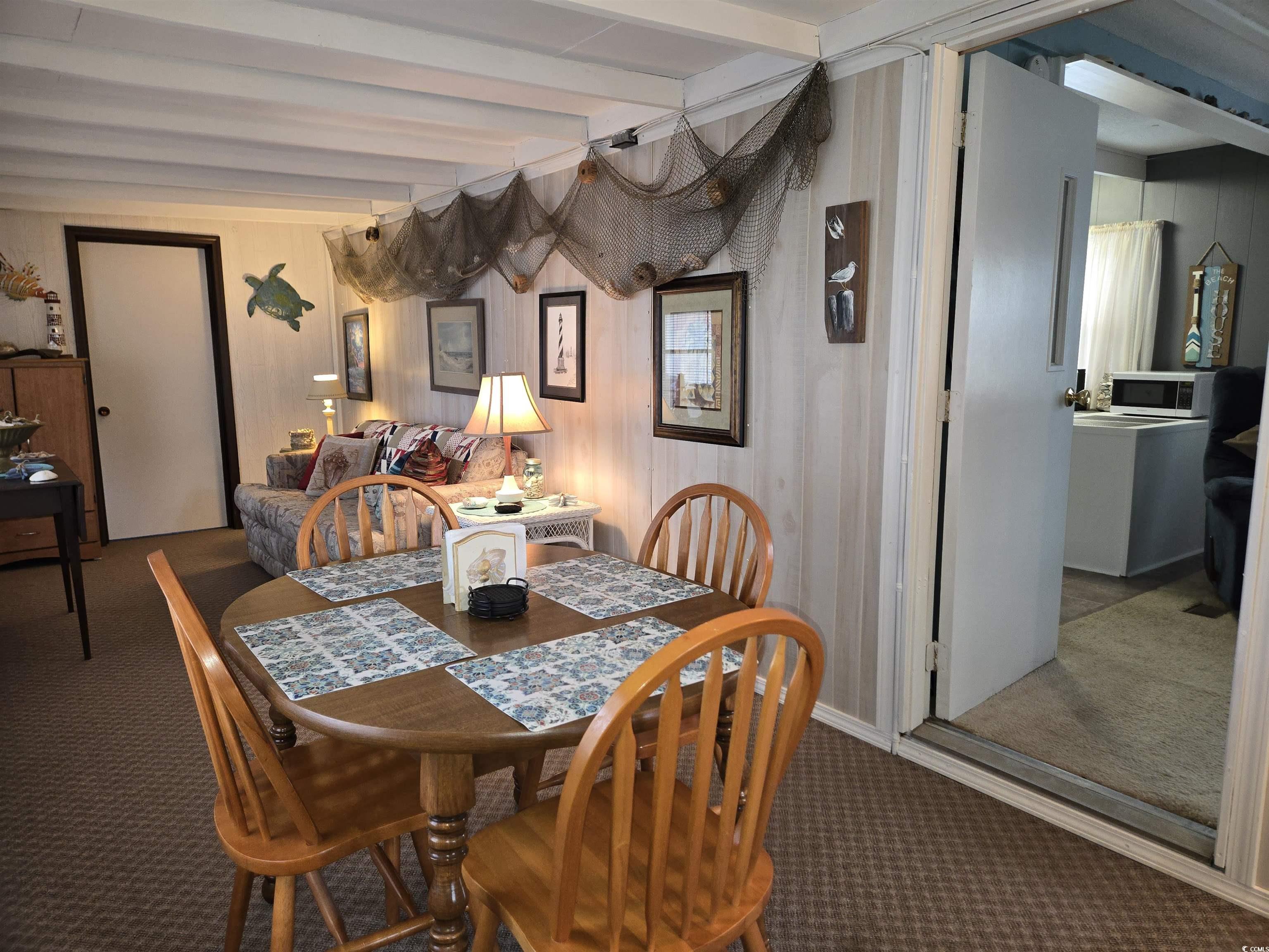 425 Delton Drive Murrells Inlet, SC 29576 - Photo 9 of 34 Carpeted dining space featuring beam ceiling