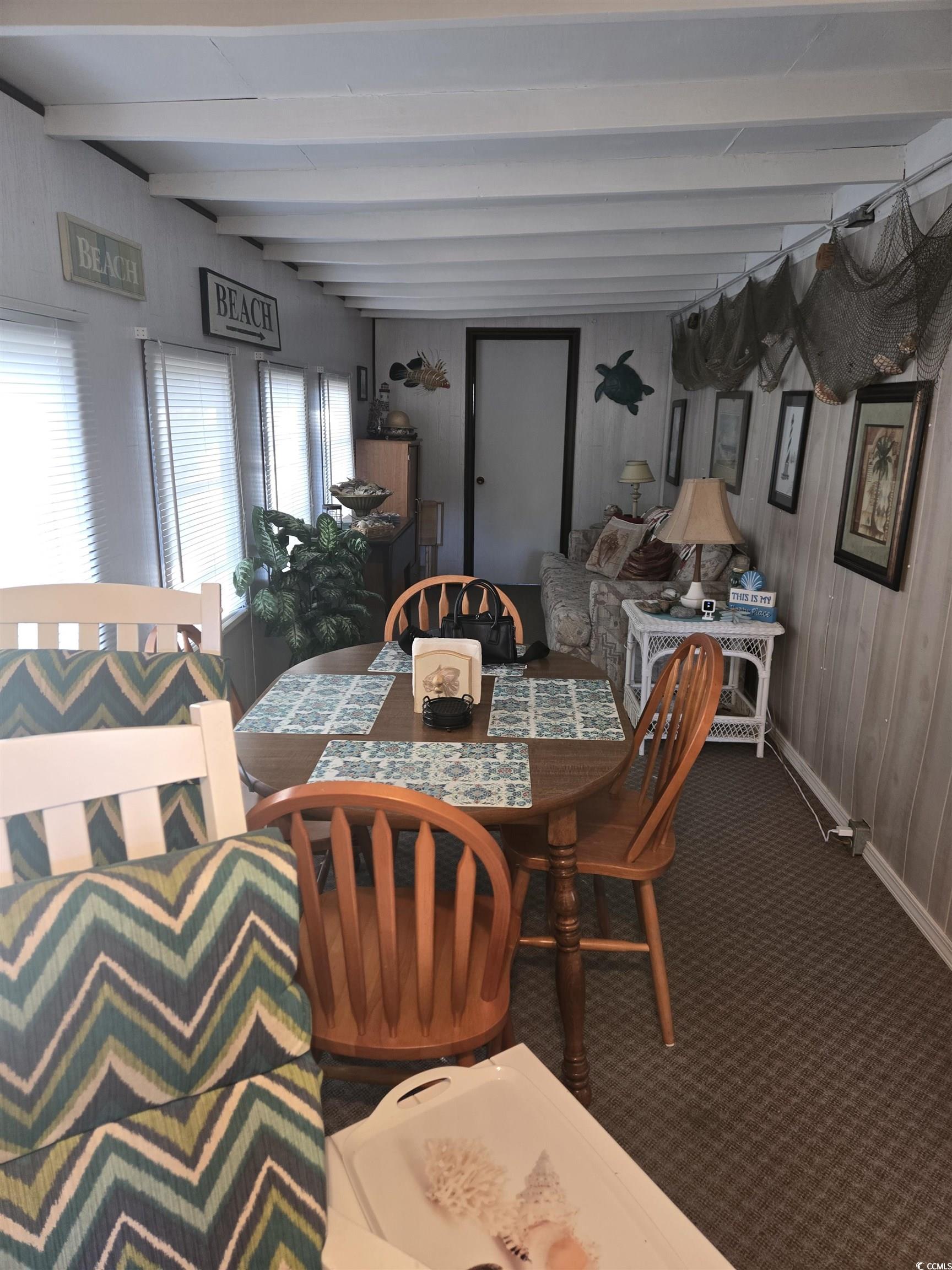 425 Delton Drive Murrells Inlet, SC 29576 - Photo 10 of 34 Carpeted dining space featuring beamed ceiling and baseboards