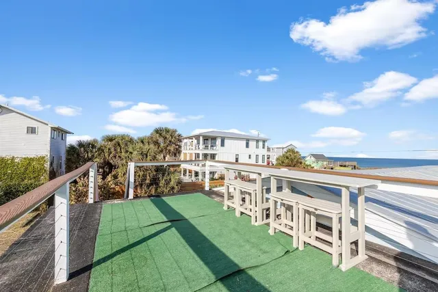 a balcony with table and chairs