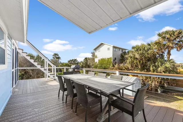 a view of a dinning tables and chairs on the roof deck