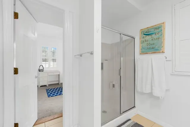 a bathroom with a shower and a sink