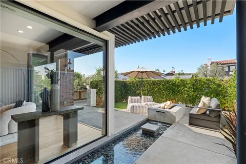 a living room with patio furniture and garden view