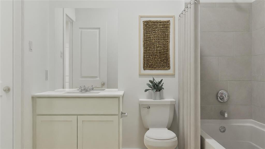 909 Tundra Loop Groveland, FL 34736 - Photo 12 of 25 a bathroom with a sink a toilet and shower