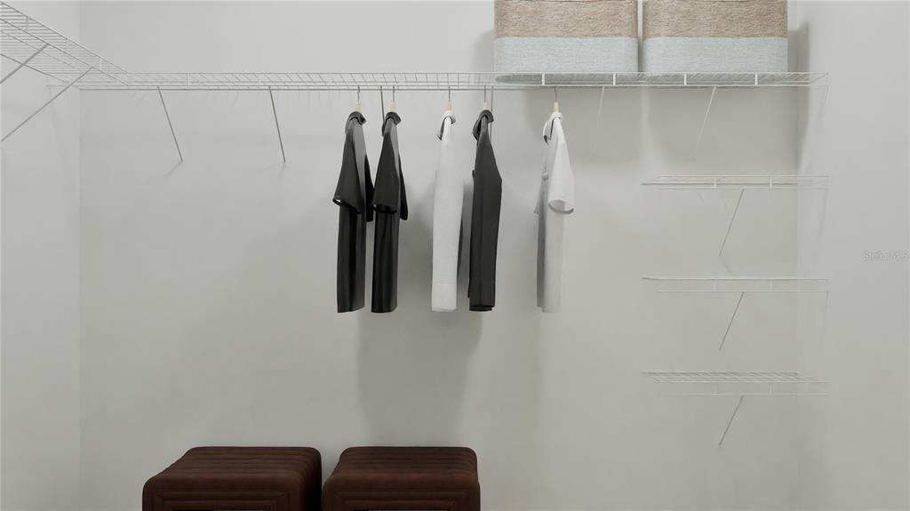 909 Tundra Loop Groveland, FL 34736 - Photo 25 of 25 a view of walk in closet with clothes