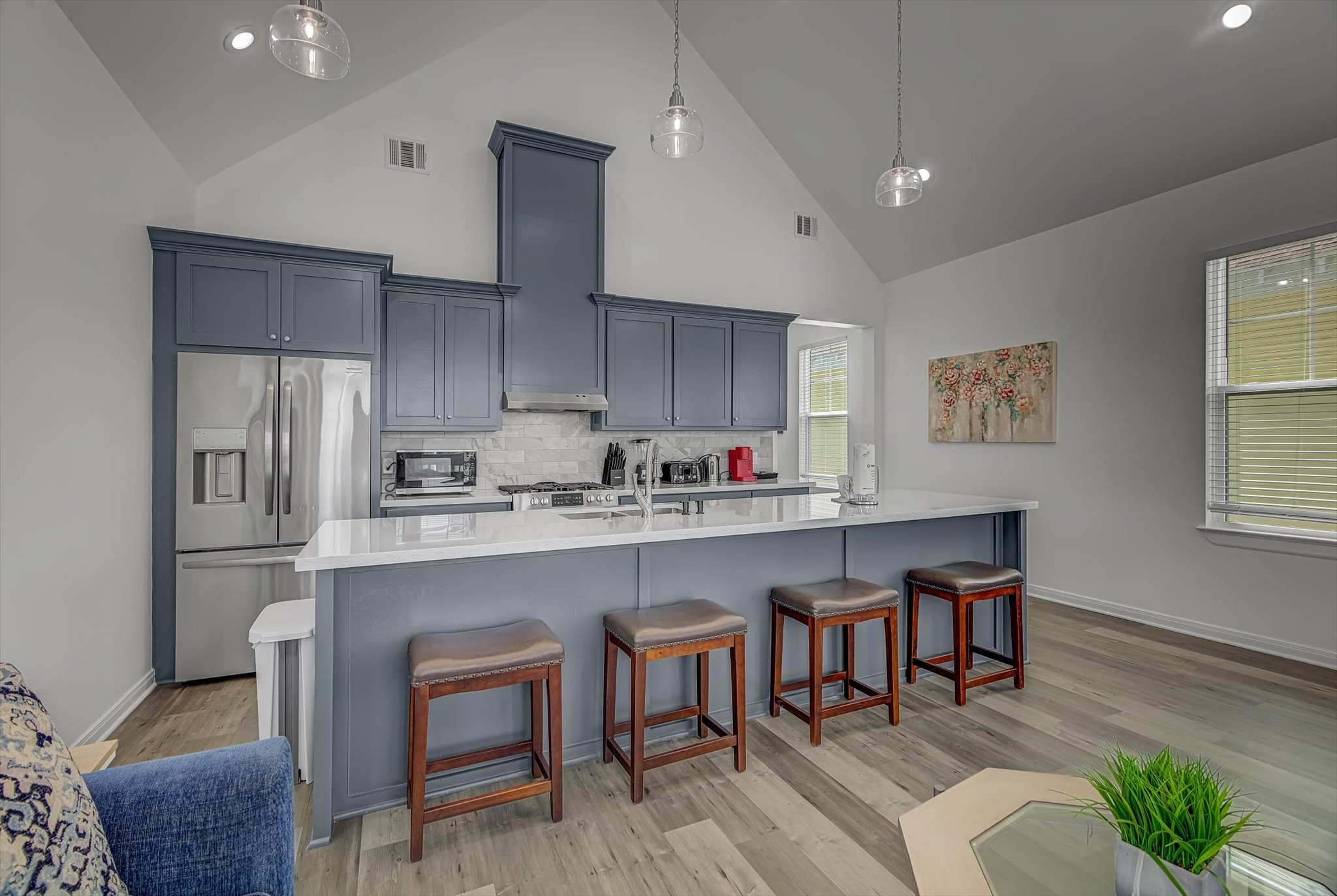 2301 67th Street Galveston, TX 77551 - Photo 14 of 46 a kitchen with stainless steel appliances granite countertop a sink and chairs