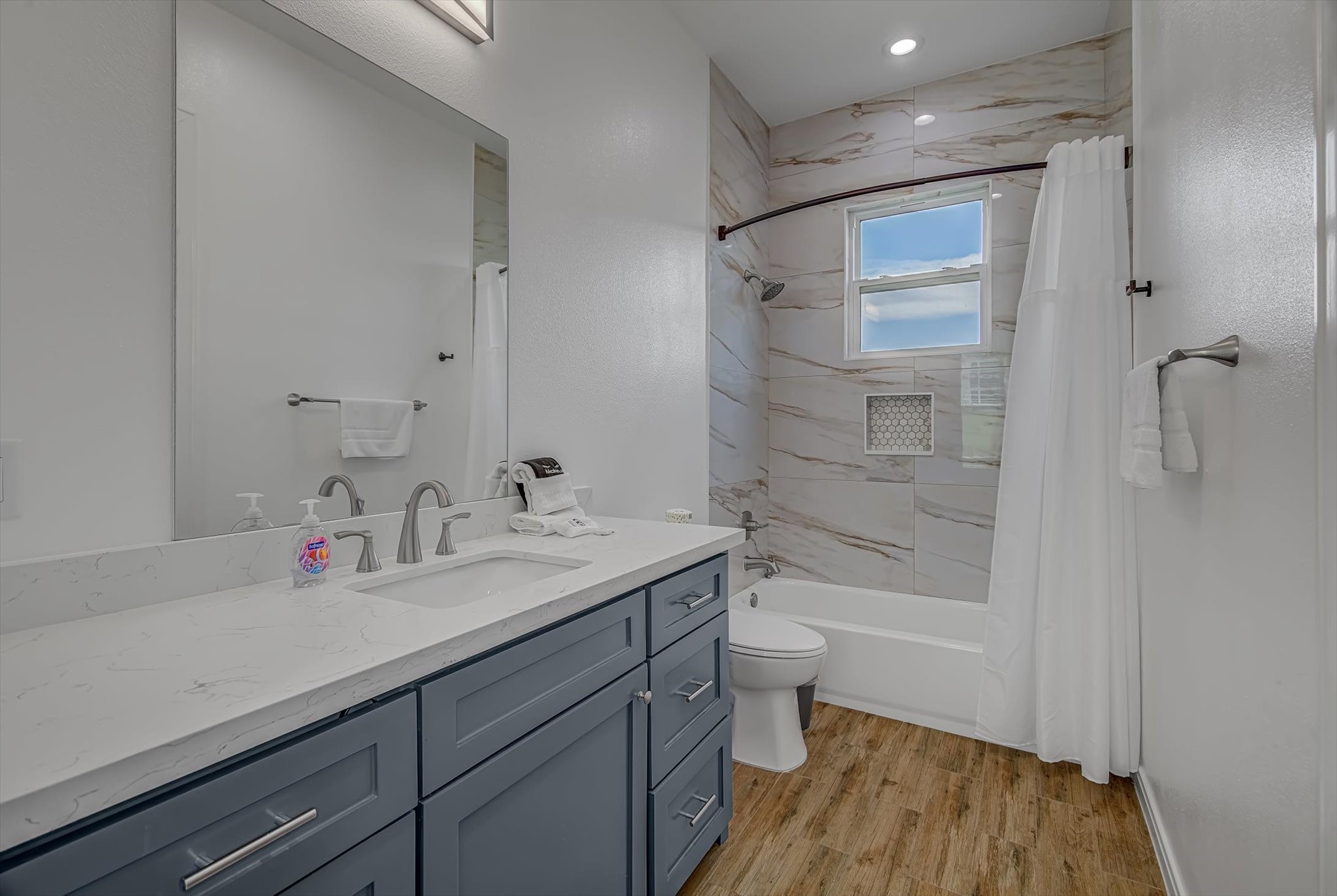 2301 67th Street Galveston, TX 77551 - Photo 22 of 46 a bathroom with a sink a toilet and shower