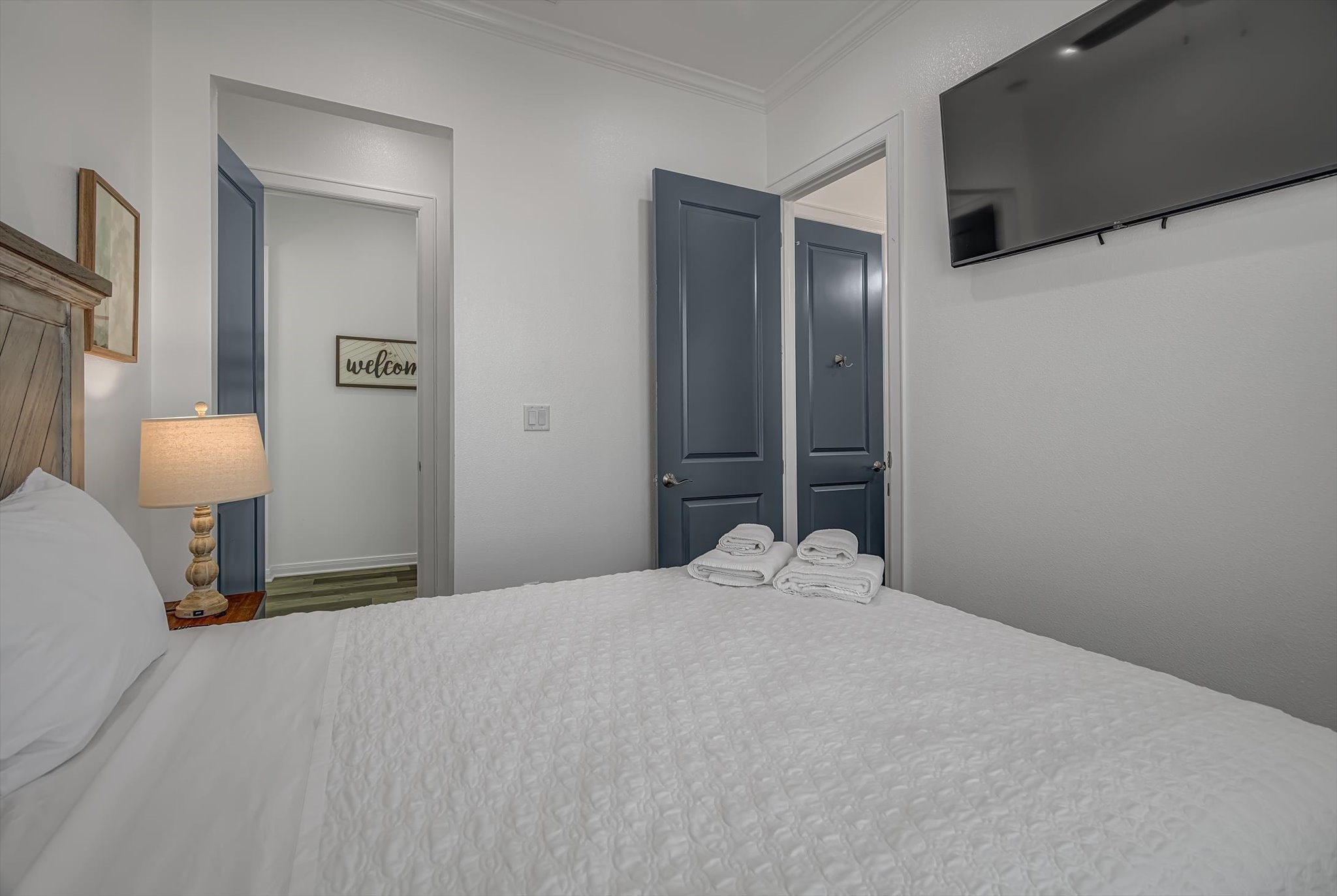 2301 67th Street Galveston, TX 77551 - Photo 26 of 46 a bedroom with a bed and a lamp