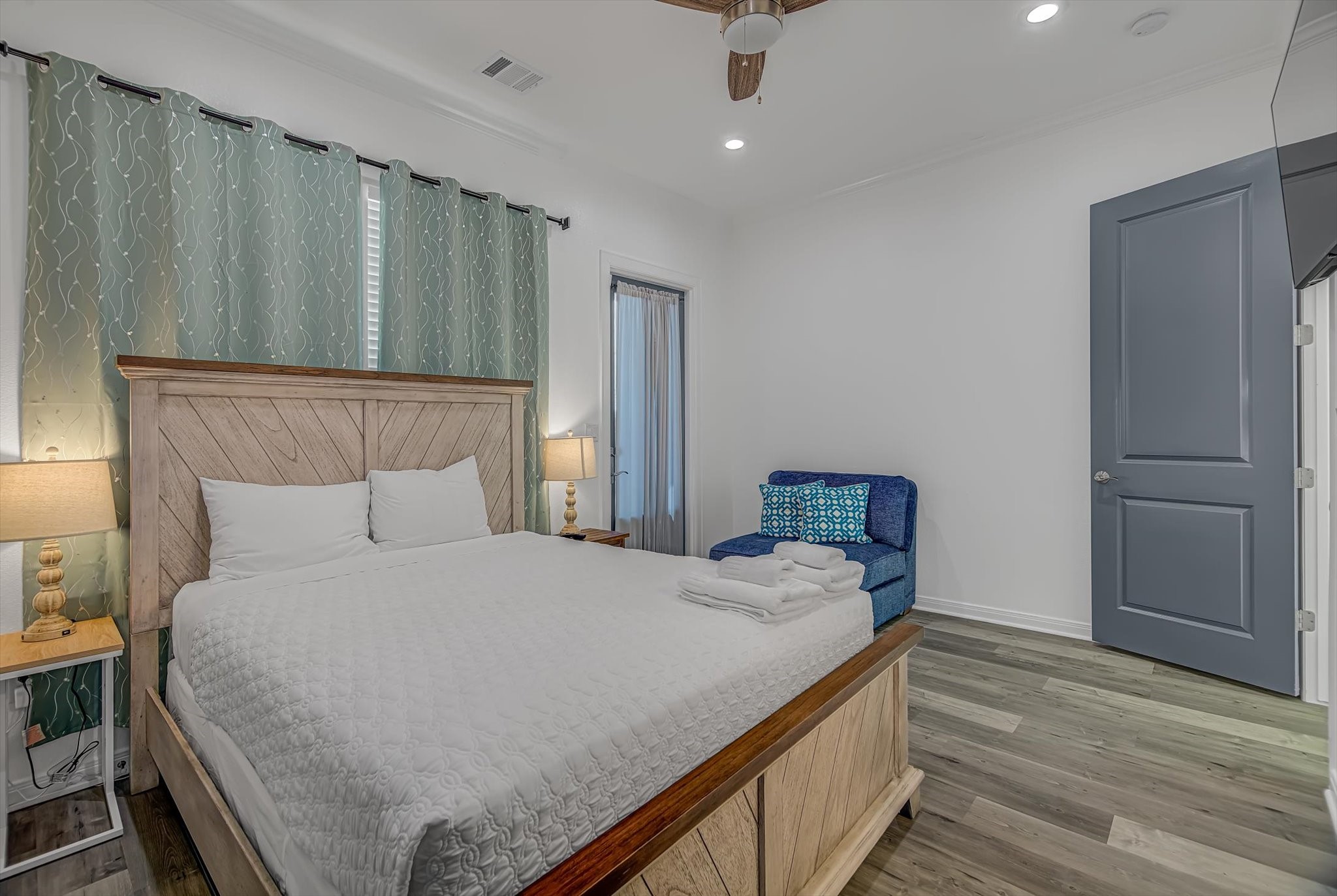 2301 67th Street Galveston, TX 77551 - Photo 28 of 46 a bedroom with a bed and wooden floor