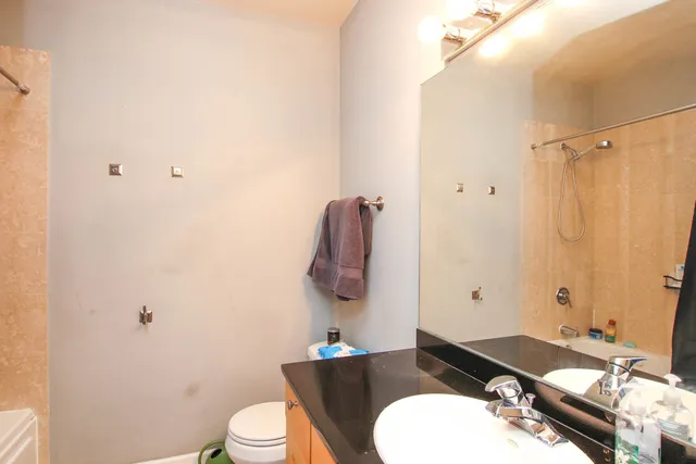 a bathroom with a sink toilet and mirror