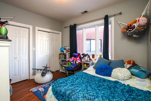 a bedroom with furniture and wooden floor