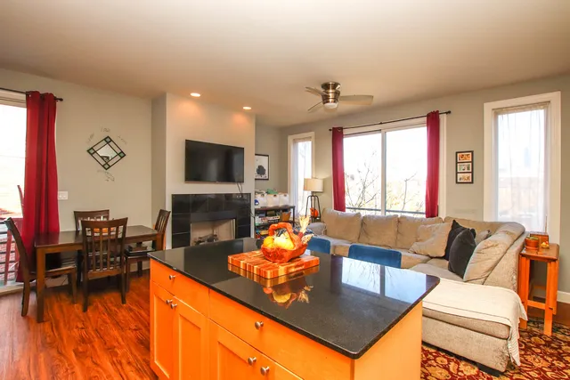 a living room with furniture a fireplace and a flat screen tv