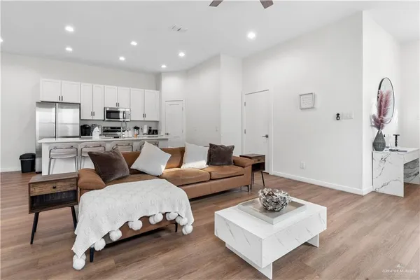 a living room with furniture kitchen and a table