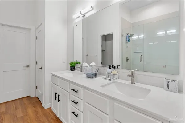 a bathroom with double vanity sink and a mirror