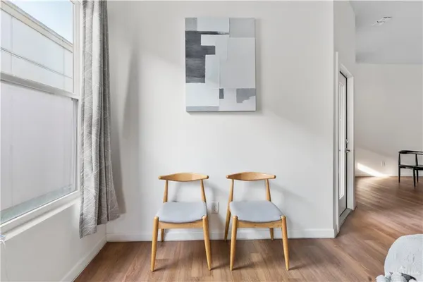 a view of a room with wooden floor and furniture