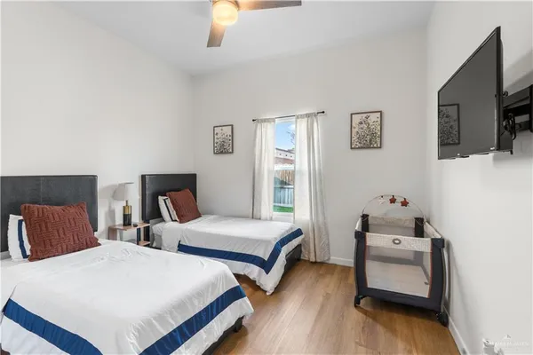 a bedroom with two beds and a tv