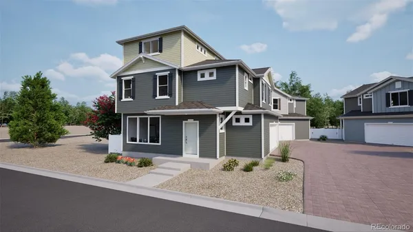 a front view of a house with garage and plants