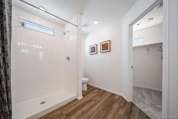 a bathroom with a shower and a glass door