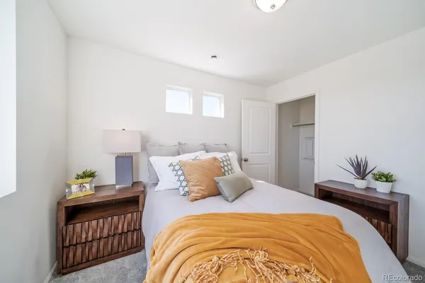 a bedroom with a bed and lamps