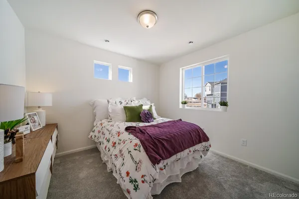 a bedroom with a bed and a lamp with window
