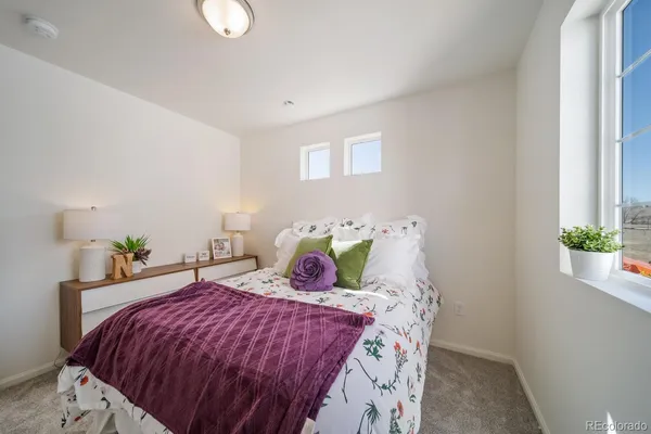 a bedroom with a bed and window