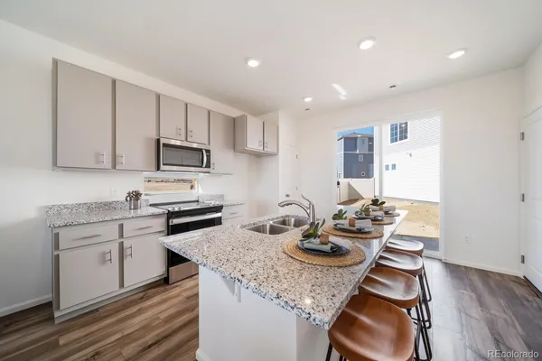 a kitchen with sink stove and cabinets
