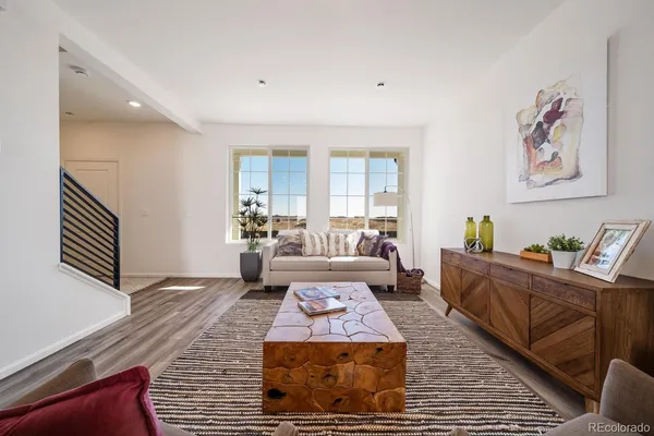 a living room with furniture and a rug