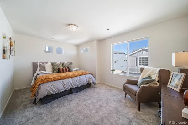 a spacious bedroom with a bed and furniture