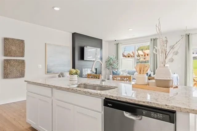 a kitchen with granite countertop a sink and a wooden floor