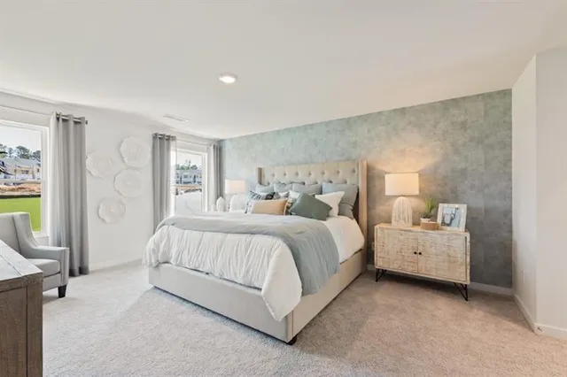 a spacious bedroom with a bed and a couch