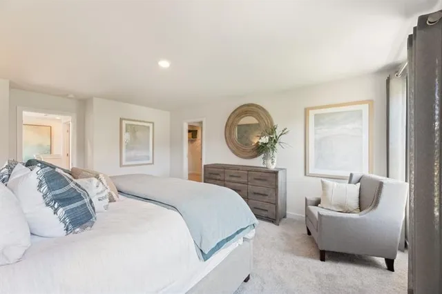 a bed room with a bed couch and a window