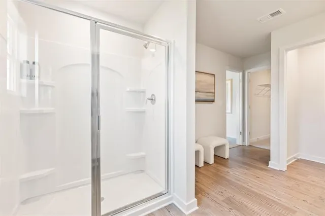 a bathroom with a glass shower door and a toilet
