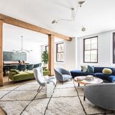 a living room with furniture and large windows