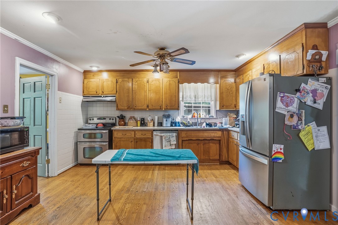 14219 Spruce Avenue Chester, VA 23836 - Photo 11 of 32 a kitchen with stainless steel appliances granite countertop a refrigerator a stove top oven a sink and dishwasher