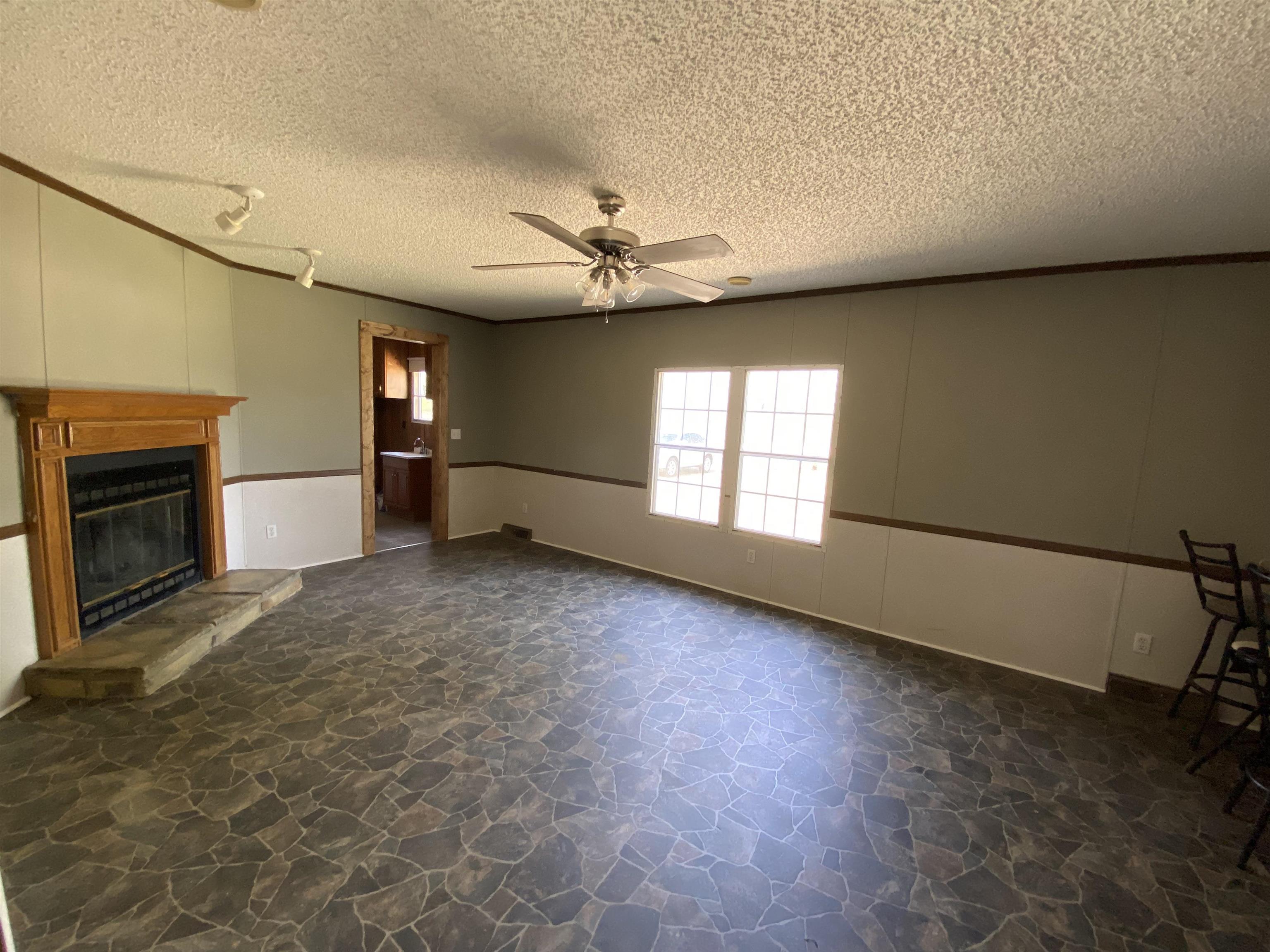 3737 Williams Switch Road Henning, TN 38041 - Photo 7 of 17 an empty room with windows and fireplace